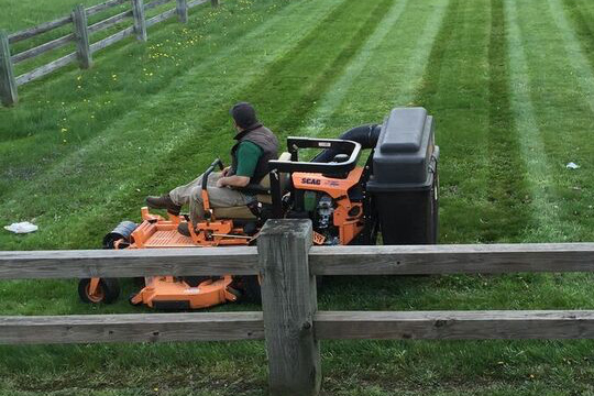 Billy Methot crew mowing clean lines on a residential lawn in Western Massachusetts